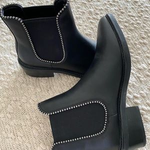 New black leather Chelsea bootie with studded elastic side panels. Size: 7.5